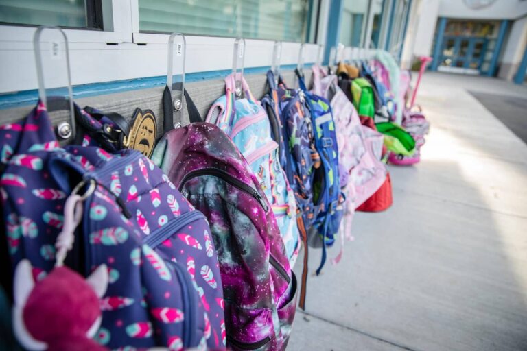 Student backpacks on hangers