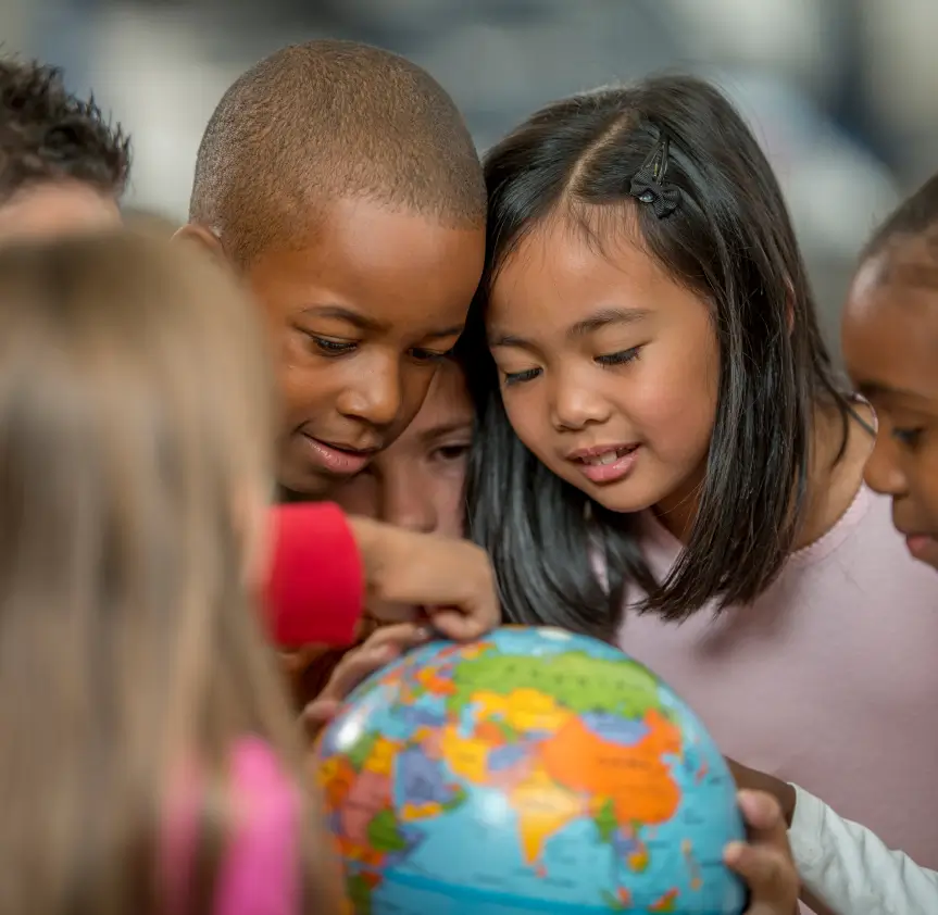 Kids looking at globe